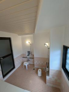 a bathroom with a toilet and a sink and two lights at Gondola House in Nozawa Onsen +26 photos