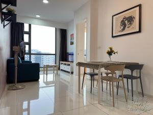 a dining room and living room with a table and chairs at Cozy Minimalist Condo In The Heart of Kuala Lumpur City 1BR in Kuala Lumpur