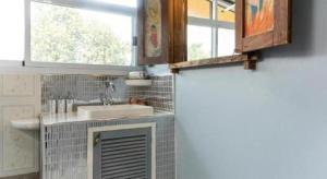 a bathroom with a sink and a mirror and a window at OYO 750 Baan Suan Ampond in Bangkok +155 photos