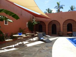a patio with a table and chairs next to a building at RIAD SAINT FRANCOIS & SPA in Rodrigues Island
