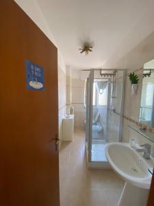 a bathroom with a shower and a sink and a toilet at SoverHouse guest house a Soverato Marina in Soverato Marina