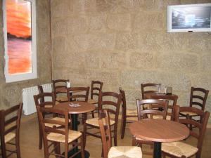 a room with tables and chairs and a brick wall at Hotel Nautico in Vigo