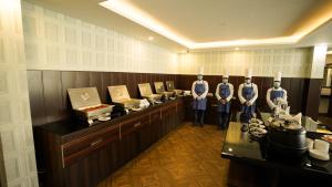 a restaurant with three mannequins in front of a counter at Jashn Wellness Resort Lucknow in Lucknow