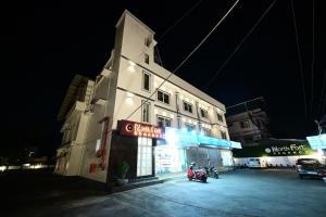 a building with a motorcycle parked in front of it at night at North Fort Regency in Cochin