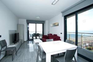 uma sala de estar com uma mesa branca e cadeiras em Apartamentos Fuengirola Playa em Fuengirola