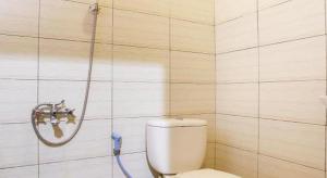 a bathroom with a toilet and a shower at OYO 3396 Sun Garden Resort in Pablengan +105 photos