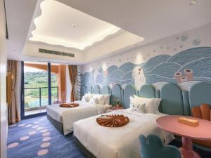 a hotel room with two beds and a wall mural at Dolphin Bay Hotel in Yanglin +291 photos