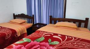 two beds sitting next to each other in a room at St. Andrews Hostel in Nuwara Eliya +31 photos