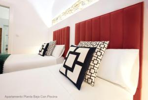 Ένα ή περισσότερα κρεβάτια σε δωμάτιο στο Apartamentos Durán Pizarro 1930