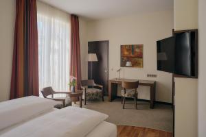 TV a/nebo společenská místnost v ubytování Aparthotel am Golfclub Treudelberg