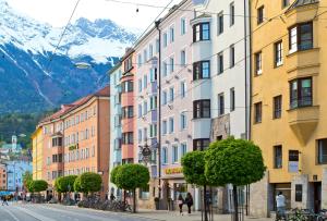 a city street filled with lots of tall buildings at Hotel Maximilian - Stadthaus Penz in Innsbruck