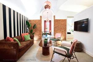a living room with a couch and chairs at Apartamentos Durán Pizarro 1930 in Mérida