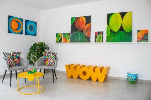a room with chairs and paintings on the wall at Hotel Arte Mare in San Vito lo Capo