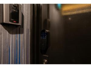a close up of a door with a remote control at Pin pon hotel & cabin Tokuyama Ekimae - Vacation STAY 86396v in Shunan +1 photo