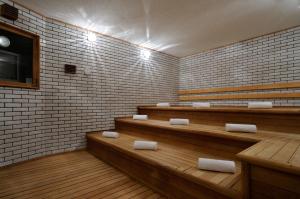 a waiting room with benches and brick walls at Hotel Emisia Sapporo in Sapporo