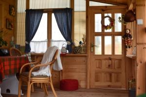 a room with a wooden door and a window at Agroturystyka w Dolinie Raty in Prusie