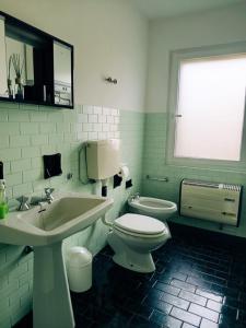 a bathroom with a white toilet and a sink at Casa Anna in Crosa +45 photos