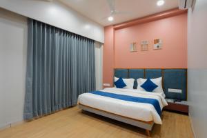 a bedroom with a large bed and a window at Prarambh By Siara in Nadiād