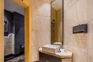 a bathroom with a sink and a mirror at Eastern Paris Girls' Youth Hotel in Shanghai