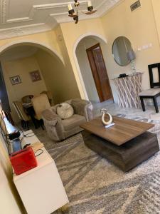 a living room with a couch and a table at Appartements et studios meublés kahak in Douala