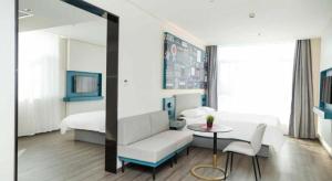 a room with a bed and a couch and a table at ibis Tianjin Wuqing Hotel in Tianjin +142 photos