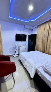 a bedroom with a bed and a blue ceiling at Kamjide Apartments in Abuja