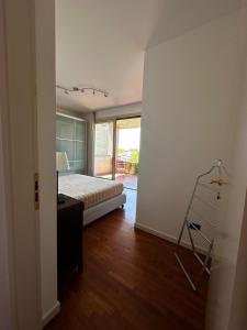 a bedroom with a bed and a desk and a ladder at Appartamento luminoso in Parma