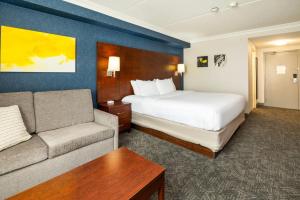 a hotel room with a bed and a couch at Comfort Inn & Conference Centre Toronto Airport in Toronto +37 photos