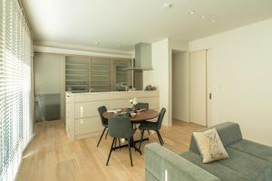 a kitchen and dining room with a table and chairs at Mova Villa Koshi 大和 2-エレベーター完備 一軒家貸切- in Yuge