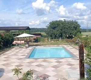 a swimming pool in the middle of a patio at Biobagnolese Agriturismo in Orte