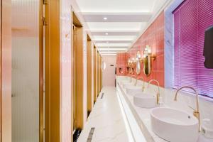 a bathroom with four sinks and a row of mirrors at Eastern Paris Girls' Youth Hotel in Shanghai +56 photos