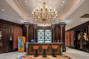 a large lobby with a chandelier and a desk at Eastern Paris Girls' Youth Hotel in Shanghai