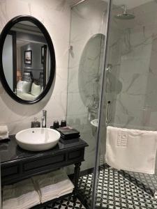 a bathroom with a sink and a shower with a mirror at Malisa Hotel in Như Thức