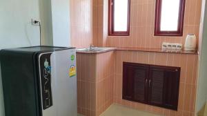 a bathroom with a refrigerator and a sink at Doungta Anda Hotel Krabi in Ban Khlong Chi Lat