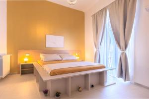a bedroom with a bed and a large window at Suites Santa Cecilia in Palermo