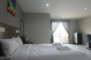 a bedroom with a white bed with two towels on it at PJ PLACE in Ban Bang Samak +32 photos