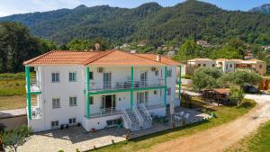 an aerial view of a house with mountains in the background at Menta Studios in Skala Potamias