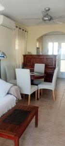 a living room with a table and white chairs at Astrid-Luise Huss in Puerto de Mazarrón
