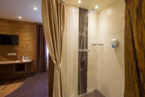 a bathroom with a shower with a shower curtain at Landgasthof Zum Lang in Gottsdorf +43 photos
