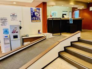 a store lobby with stairs and a refrigerator at The Hamilton Sapporo Hotel in Sapporo