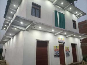 a building with lights on the side of it at Hotel O by OYO Allahabad Property in Bhīta +1 photo