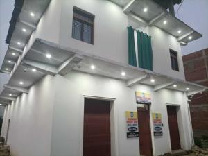 a white building with lights on top of it at Hotel O by OYO Allahabad Property in Bhīta