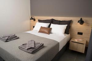 a bedroom with a bed with a towel on it at DG space 1A in Kalamata