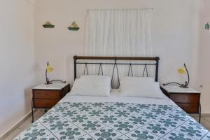 a bedroom with a bed and a lamp at Christos Apartments Oia in Oia