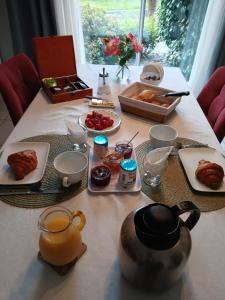 a table with food and a tea pot on it at Chez Bernard et Nicole in Betton