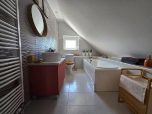 a bathroom with a sink and a tub and a toilet at FÜGE - Füredi füge terasz in Balatonfüred +11 photos