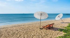 two beach chairs and umbrellas on a beach at JP Place in Ko Lanta