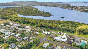 an aerial view of a town with a lake at Castaway at Pelican in Pelican Flat +13 photos
