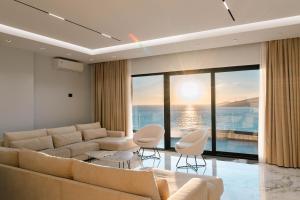 a living room with a couch and a table and chairs at Day Lux Superior Apartments in Sarandë