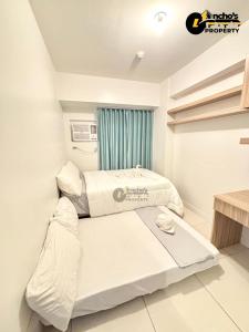 a small bedroom with a bed and a window at Luxurios 1 bedroom unit horizons101 in Cebu City